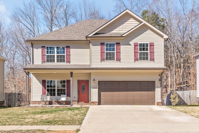 view of front of home featuring driveway, a shingled roof, a front yard, and fence