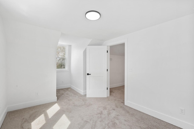 unfurnished room featuring carpet and baseboards