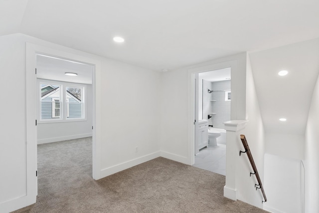 hallway with an upstairs landing, recessed lighting, light carpet, and baseboards