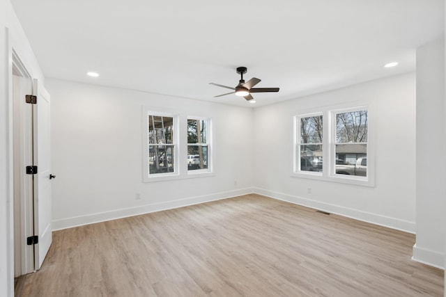 unfurnished room with plenty of natural light, light wood-style floors, and ceiling fan