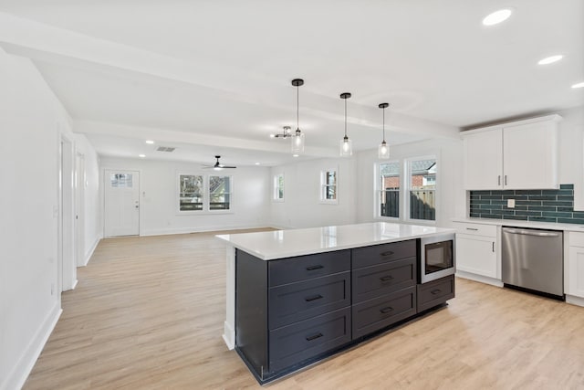 kitchen featuring dishwasher, white cabinetry, and light countertops