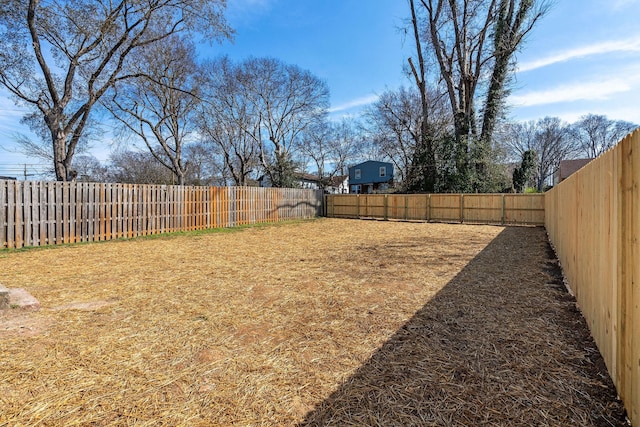 view of yard with a fenced backyard