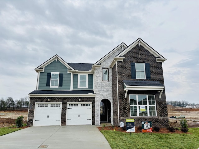 view of front of property featuring a garage, brick siding, and driveway