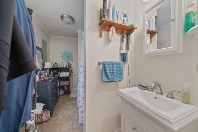 full bath featuring vanity, baseboards, and ornamental molding