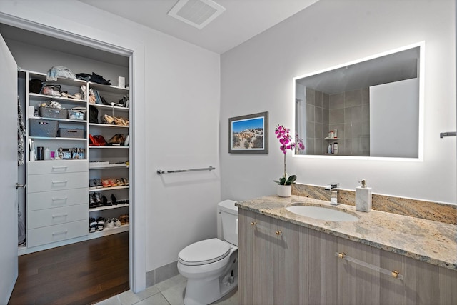515 Church St Unit 3408, Nashville, TN 37219 - full bath featuring visible vents, a walk in closet, toilet, wood finished floors, and vanity
