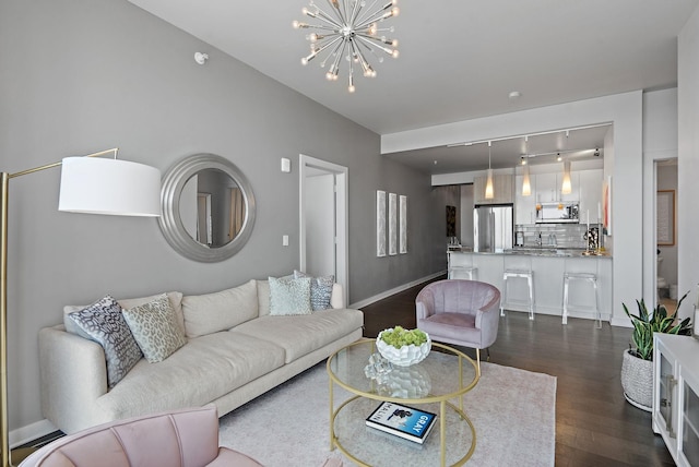 515 Church St Unit 3408, Nashville, TN 37219 - living room with baseboards, dark wood-type flooring, and an inviting chandelier