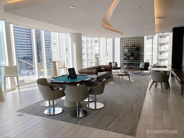 515 Church St Unit 3408, Nashville, TN 37219 - recreation room with plenty of natural light, a fireplace, wood tiled floor, and expansive windows