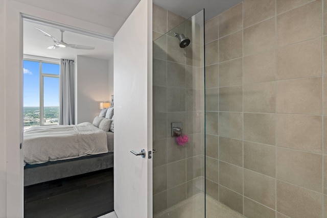515 Church St Unit 3408, Nashville, TN 37219 - ensuite bathroom featuring ensuite bath, wood finished floors, a ceiling fan, and a tile shower