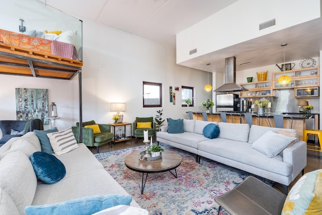 living room featuring wood finished floors and visible vents