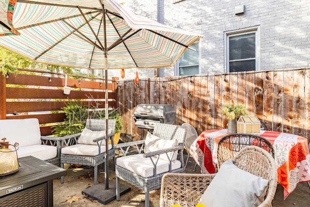 view of patio / terrace featuring grilling area, outdoor lounge area, and fence