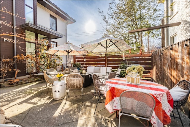 view of patio / terrace featuring fence and an outdoor hangout area