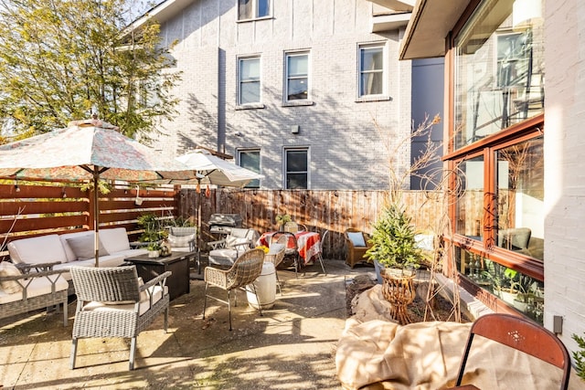 view of patio featuring an outdoor living space and fence