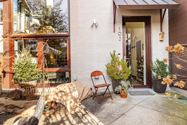 property entrance with brick siding