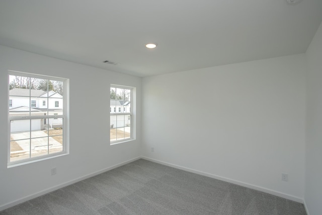 unfurnished room featuring visible vents, carpet flooring, recessed lighting, and baseboards