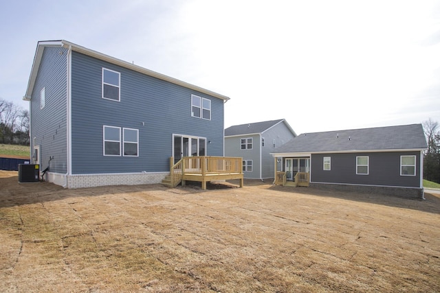 rear view of property featuring cooling unit and a deck