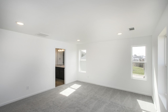 carpeted empty room with recessed lighting, baseboards, and visible vents