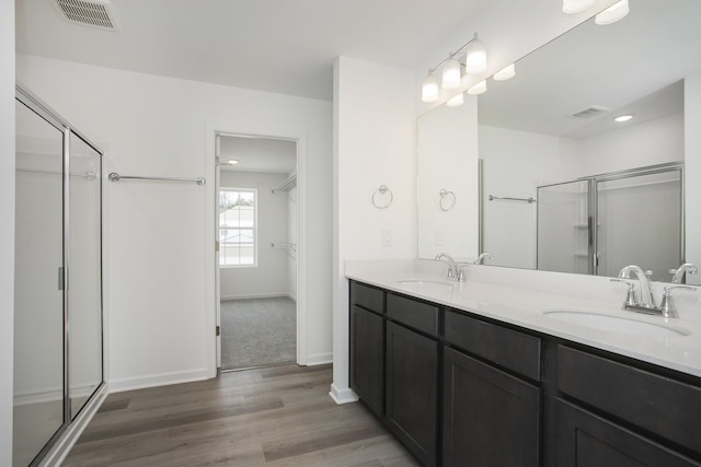 bathroom featuring a sink, visible vents, and a stall shower