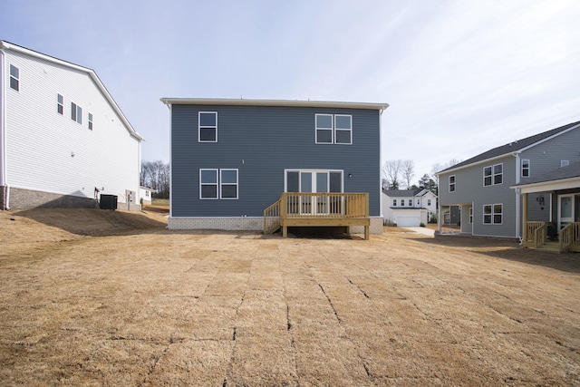 back of house with a deck and cooling unit