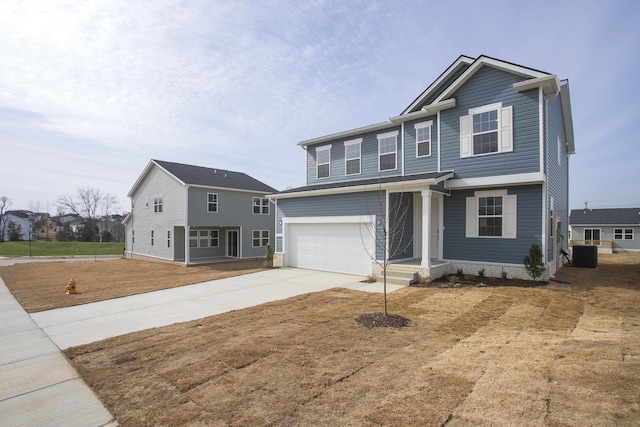 view of front of home featuring central AC unit, an attached garage, and driveway