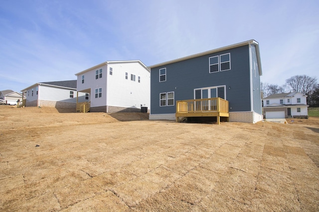 back of property with central AC unit and a wooden deck