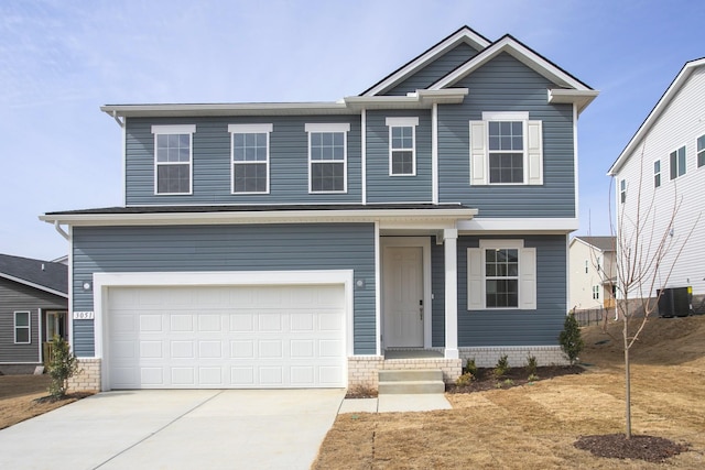 traditional home with cooling unit, a garage, and driveway