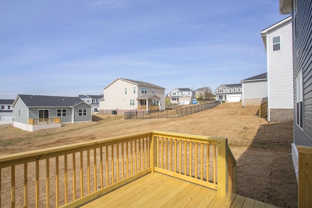 wooden terrace featuring fence and a residential view