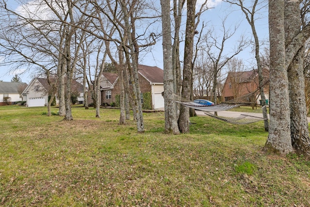 view of yard with a residential view and an attached garage