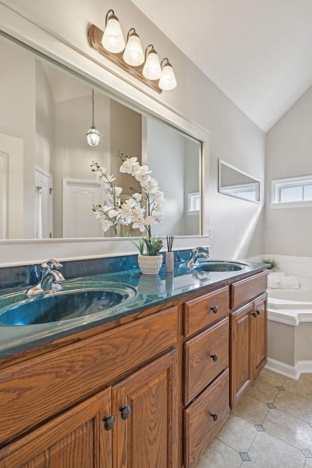 full bathroom featuring tile patterned floors, vaulted ceiling, double vanity, and a sink