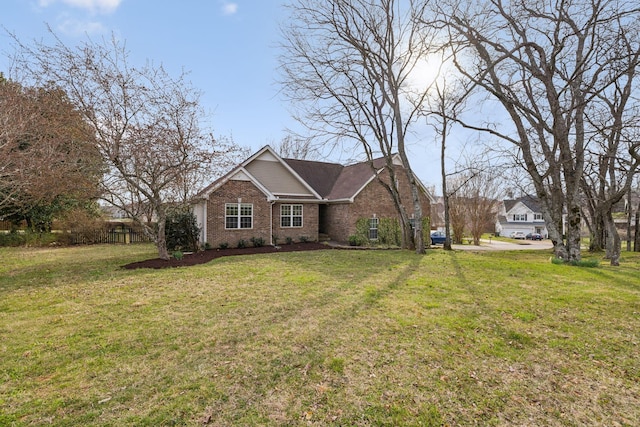 view of front of property featuring brick siding and a front lawn