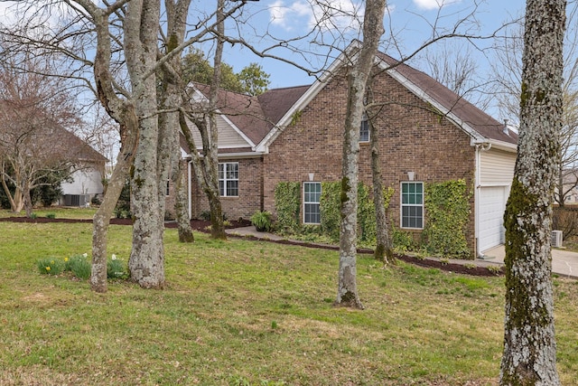 view of front of property with a garage, brick siding, and a front lawn