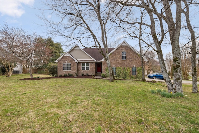 traditional-style home with a front yard and brick siding