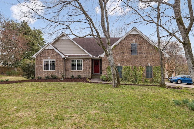 view of front of property featuring a front lawn and brick siding