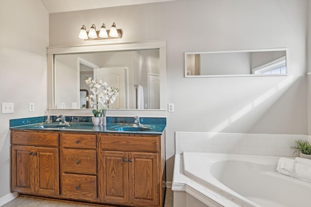 full bathroom with double vanity, tile patterned flooring, a garden tub, and a sink