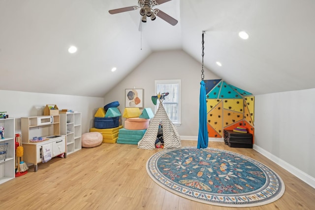 playroom with a ceiling fan, wood finished floors, recessed lighting, baseboards, and vaulted ceiling