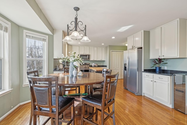 dining space with recessed lighting, baseboards, and light wood-style floors