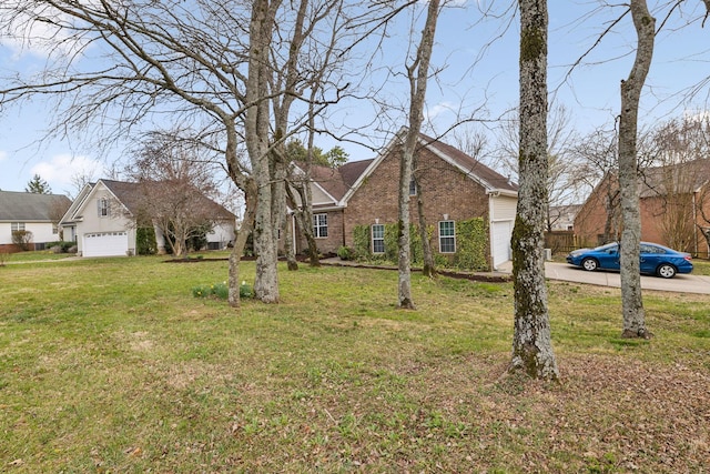 view of front of home featuring a front lawn, concrete driveway, brick siding, and a garage