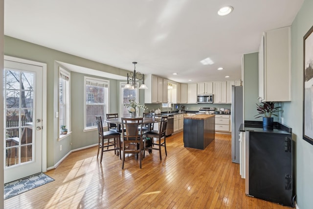 dining area featuring plenty of natural light, recessed lighting, and light wood-type flooring