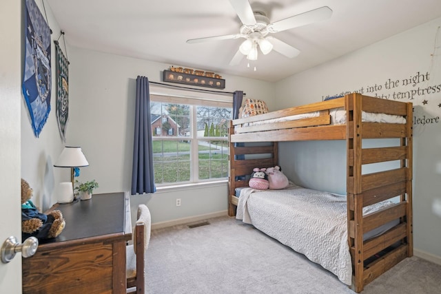 carpeted bedroom with visible vents, a ceiling fan, and baseboards