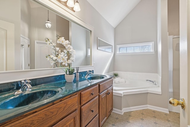 bathroom featuring a sink, lofted ceiling, a garden tub, and double vanity