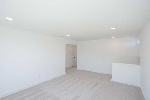 unfurnished room featuring recessed lighting, baseboards, and light colored carpet