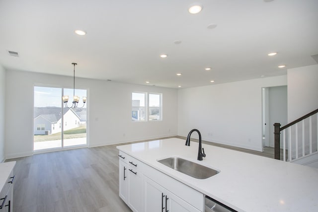 kitchen featuring open floor plan, recessed lighting, visible vents, and a sink