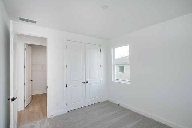 2359 Williamsport Lndg, Columbia, TN 38401 - unfurnished bedroom featuring baseboards, a closet, light colored carpet, and visible vents