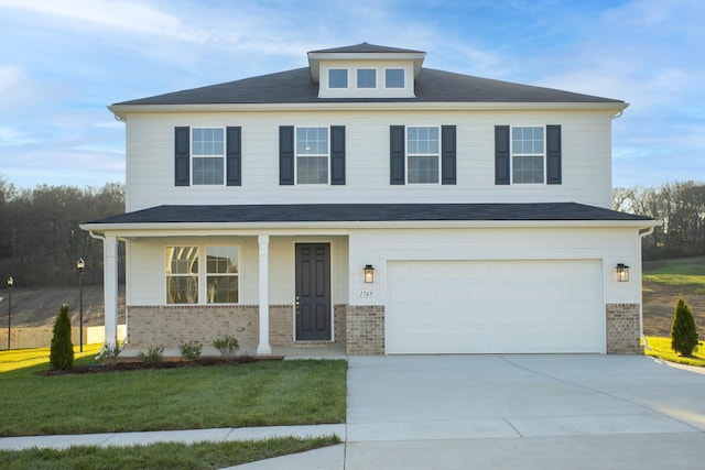 view of front of house with brick siding, an attached garage, and driveway