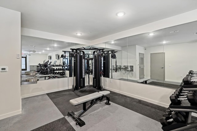 workout area featuring recessed lighting and baseboards