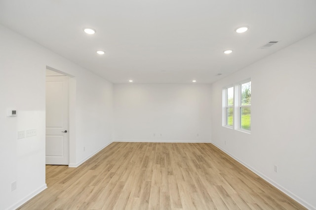 empty room with recessed lighting, light wood-style flooring, visible vents, and baseboards