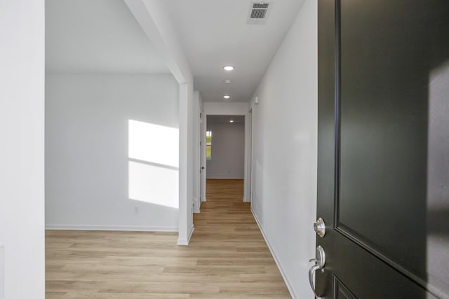 hall with light wood-type flooring, visible vents, baseboards, and recessed lighting