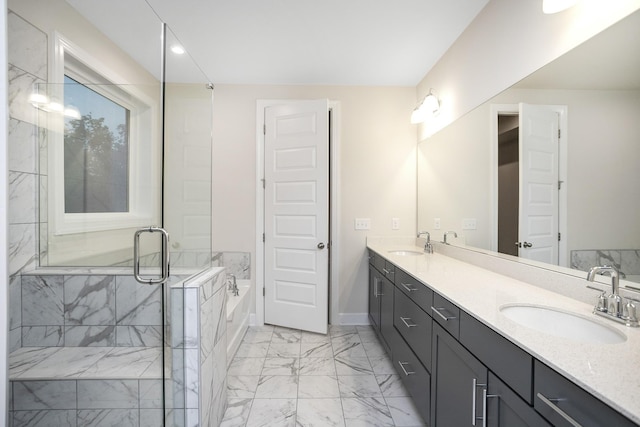 full bath with a bath, marble finish floor, a shower stall, and a sink