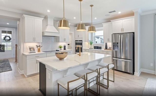 kitchen featuring visible vents, ornamental molding, custom range hood, appliances with stainless steel finishes, and white cabinetry