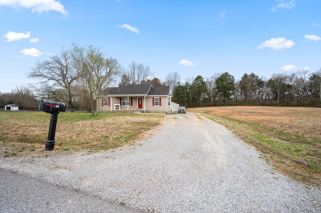 ranch-style house with a front lawn and driveway