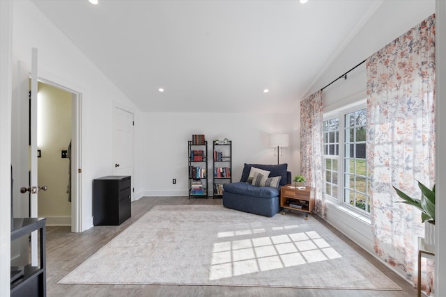 sitting room with lofted ceiling, wood finished floors, recessed lighting, and baseboards